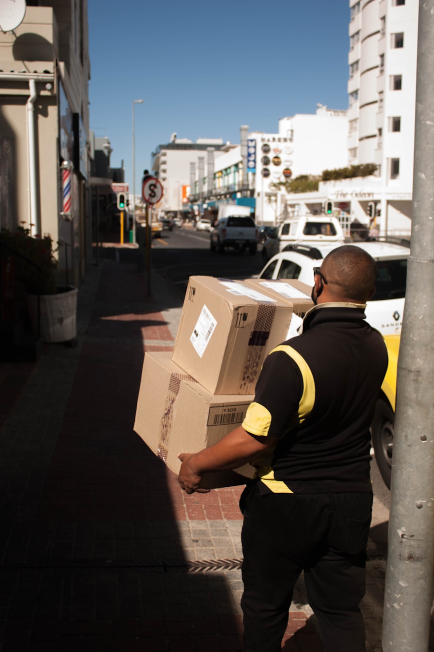 PacketRide courier moving a parcel through a logistics facility
